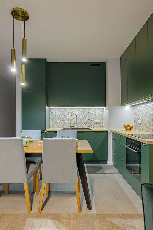 Green kitchen with natural light - a serene ambiance in the Classic Package.